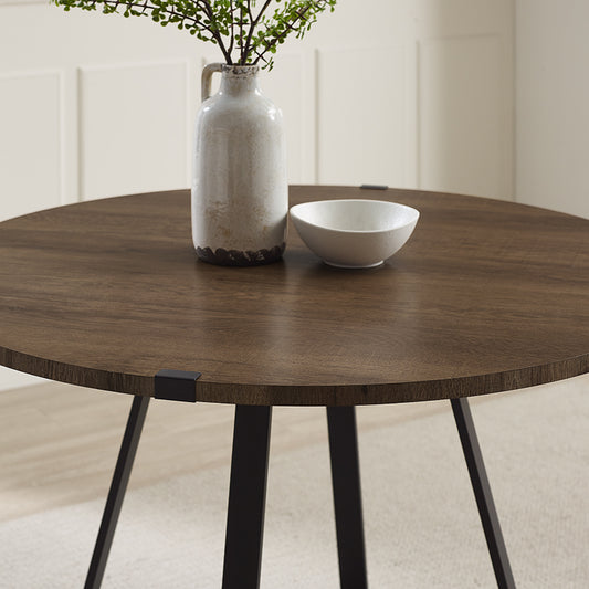 Criterion Capri Dining Table 1150mm Round Table, Black Metal Leg and Metal Highlights Dark Oak